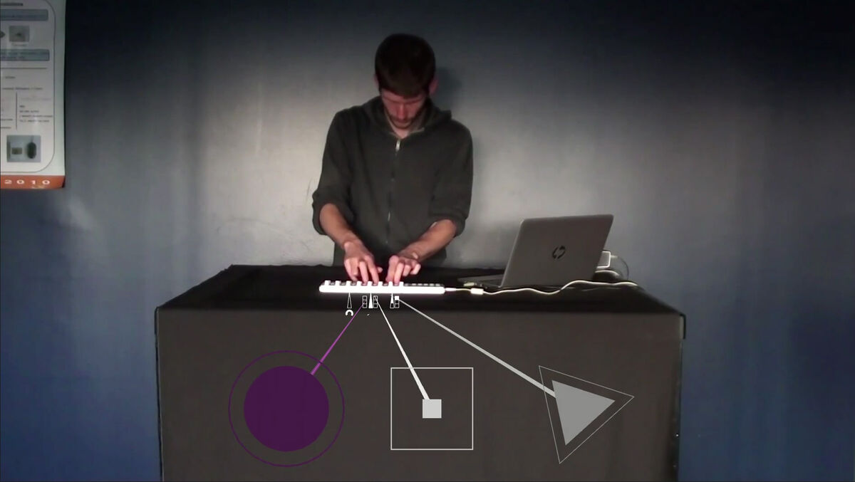 A musician playing a Digital Music Intsrument with surimposed graphic shapes.